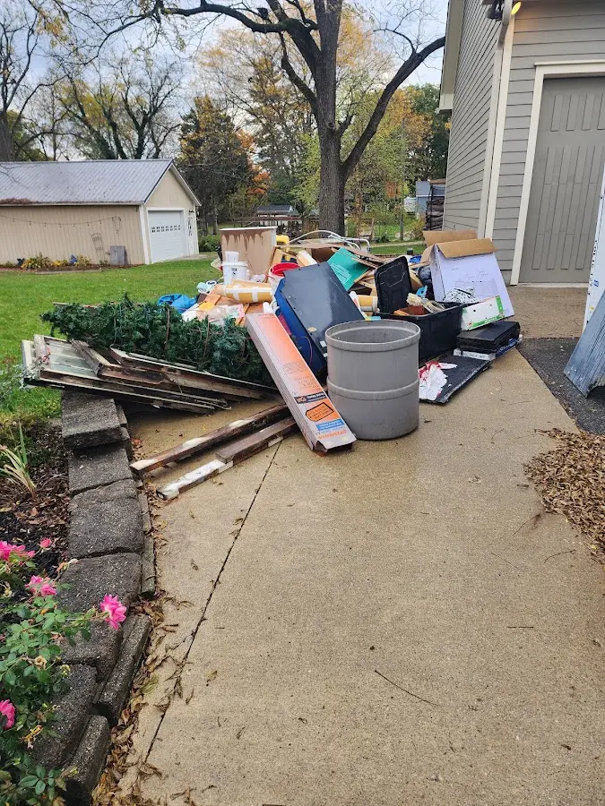 Dumpster being loaded with debris for 12 Yard Dumpster Rental in Schuyler